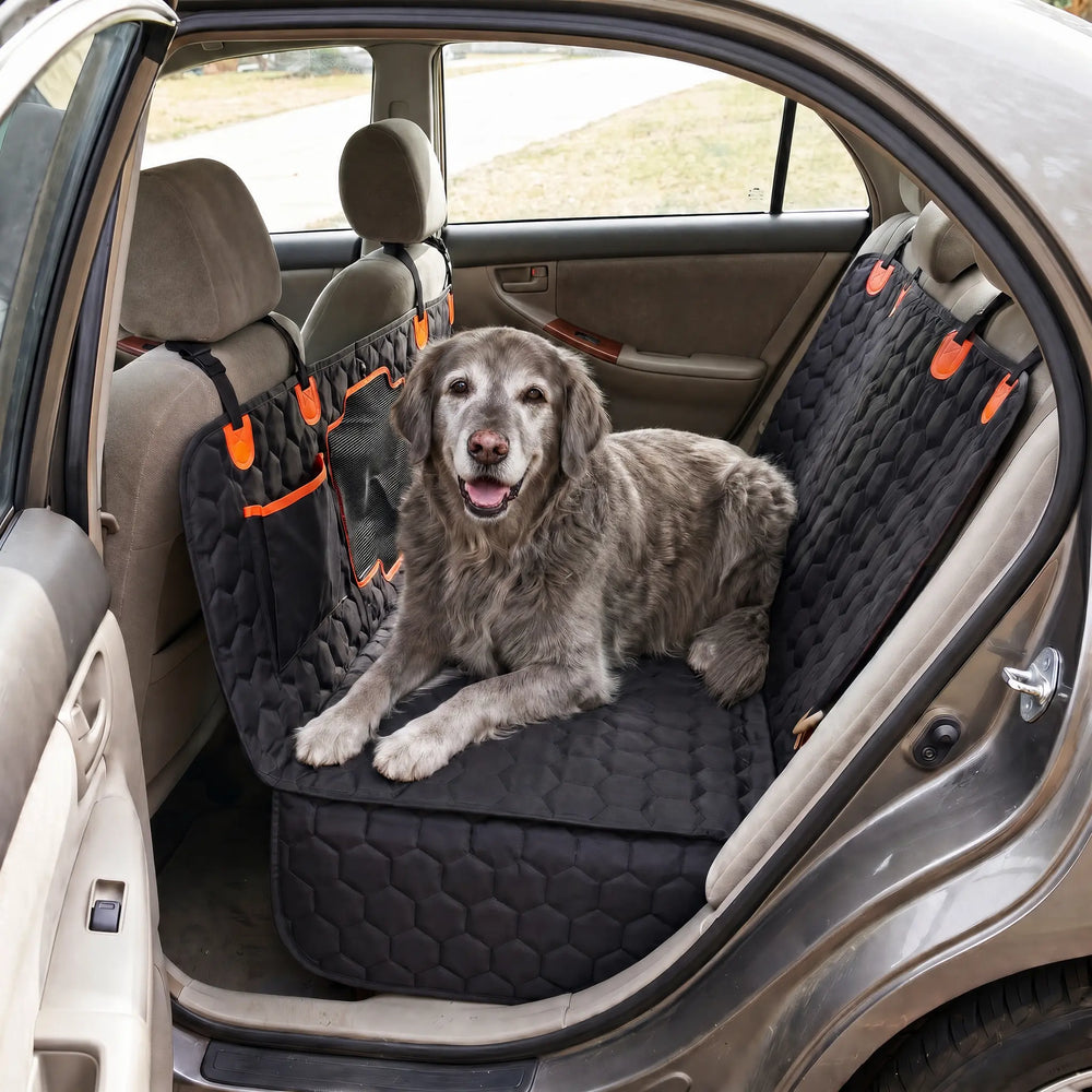 The same senior dog lying comfortably on the flat, firm surface of a SilverHammock hard-bottom seat cover in the same sedan